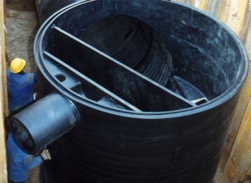 Storm water tank being placed in trench