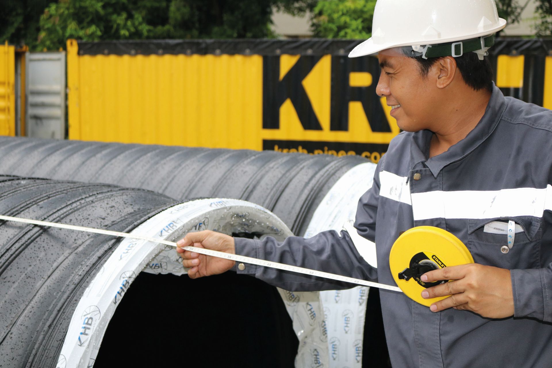A staff member measuring out the pipe profile