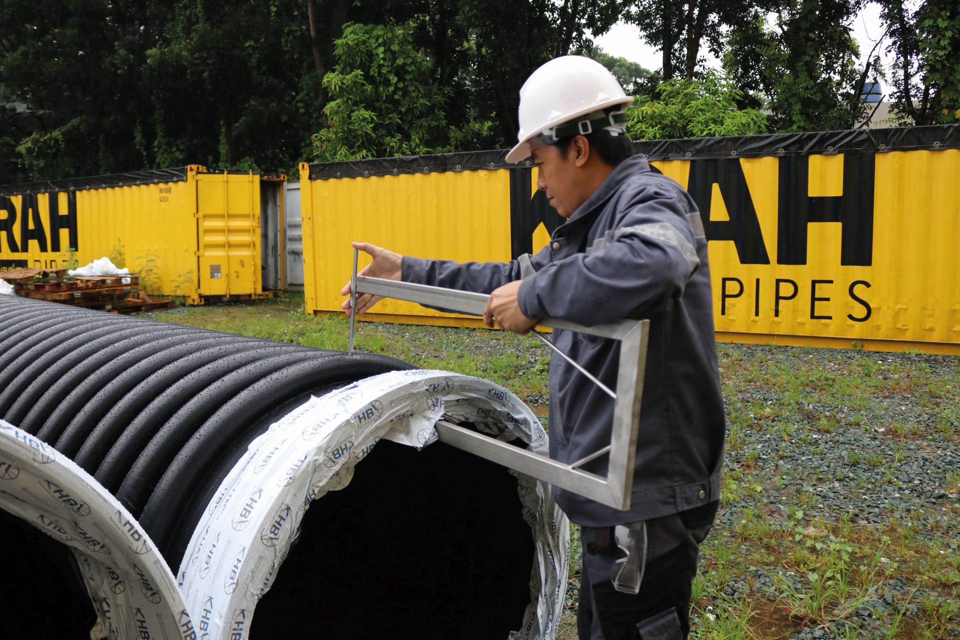 A staff member measuring out the pipe profile