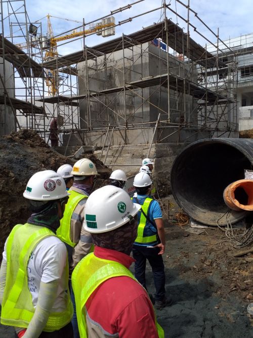 Krah workers in front of pipes
